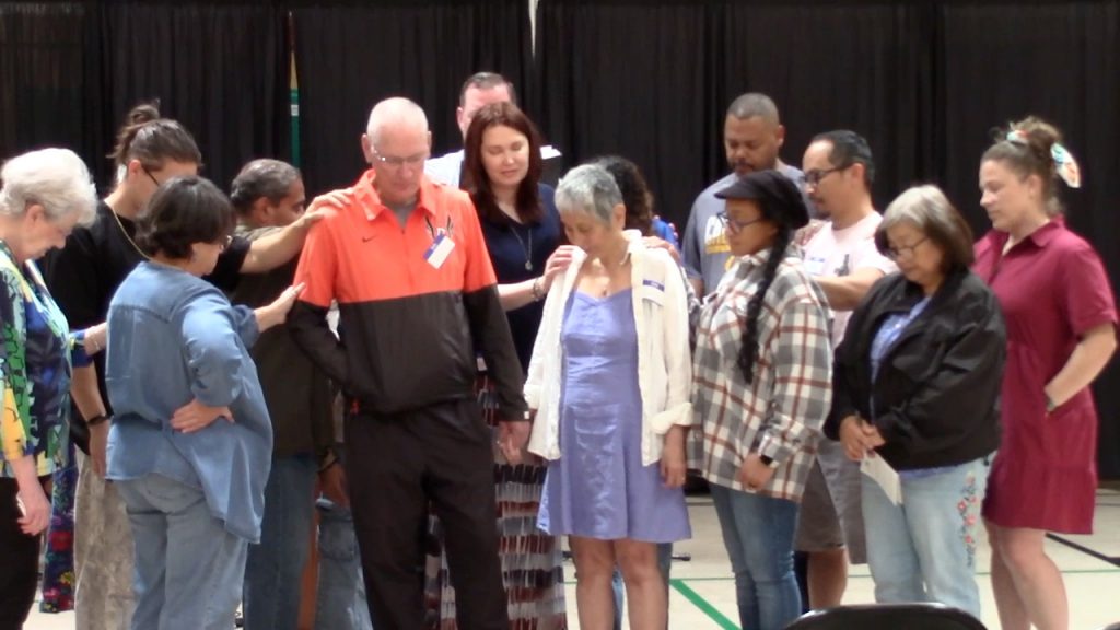 Edgewater members and regular attenders surround and pray for Kevin and Sandy as the newest members.